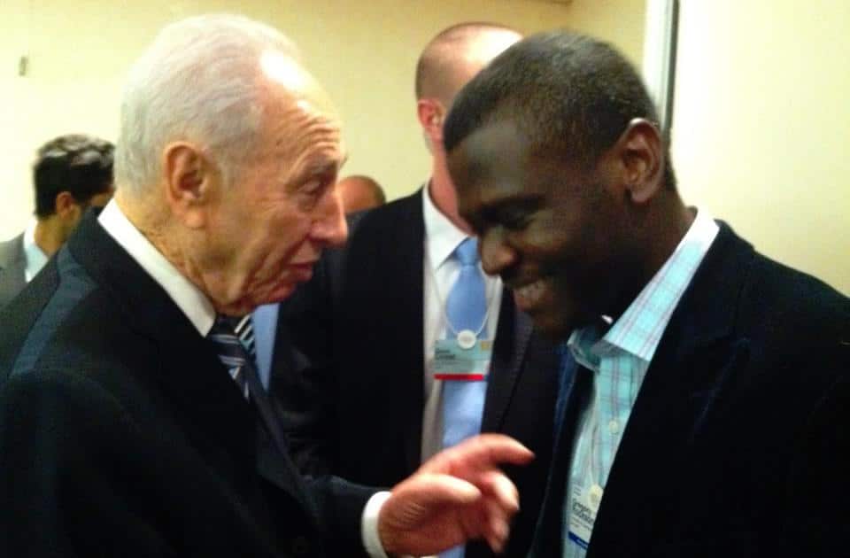 Gregory Rockson (right) talks with Israeli President Shimon Peres at the World Economic Forum’s annual meeting in Davos.